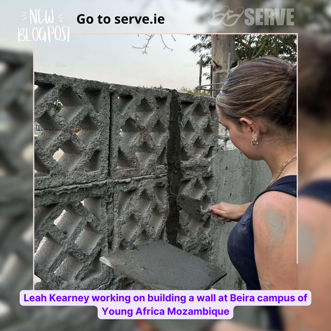 SERVE volunteer building a wall
