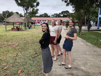 Three SEERVE volunteers standing in Young Africa campus in Beira, Mozambique