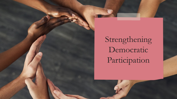  A circle formed by a range of hands held together. A rectangle inset into the larger frame reads: "Strengthening Democratic Participation"
