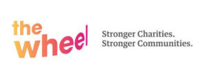 The Wheel logo in orange and pink gradient text, with the words Stronger Charities. Stronger Communities. in gray on a white background.