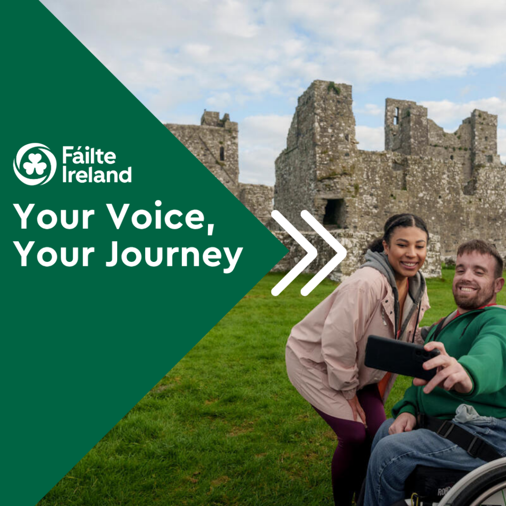A man in a wheelchair and a woman take a selfie in front of ancient stone ruins. The text reads Fáilte Ireland. Your Voice, Your Journey. Green geometric shapes are on the left side of the image.